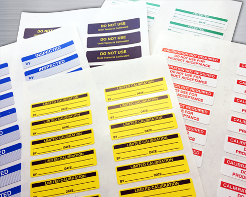 An image of rectangular removable quality control labels showing a variety of legends and colors.