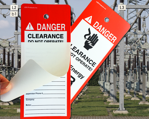 An image of two, red switchgear tags, or switch tags, reading, "Danger, Clearance, Do not opertate" with a grahic image of a hand and a live electrical wire. The second tag shows a self-laminating cover. both tags are shown in front of an electrical substation where such tags would be used.