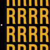 An image of a sheet of 16 retroreflective high intensity prismatic numbers & letters sized to fit in a 3-ring binder. Charaters are orange on a black background. The legend is, "R".