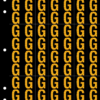 An image of a sheet of 70 retroreflective high intensity prismatic numbers & letters sized to fit in a 3-ring binder. Characters are orange on a black background. The legend is, "G".