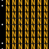 An image of a sheet of 70 retroreflective high intensity prismatic numbers & letters sized to fit in a 3-ring binder. Characters are orange on a black background. The legend is, "N".