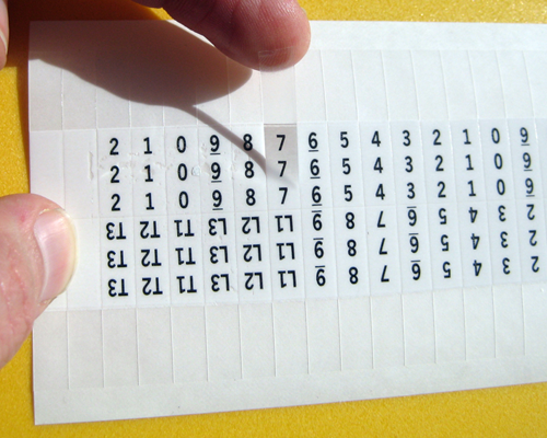 A wire marker card with individual wire and cable markers.